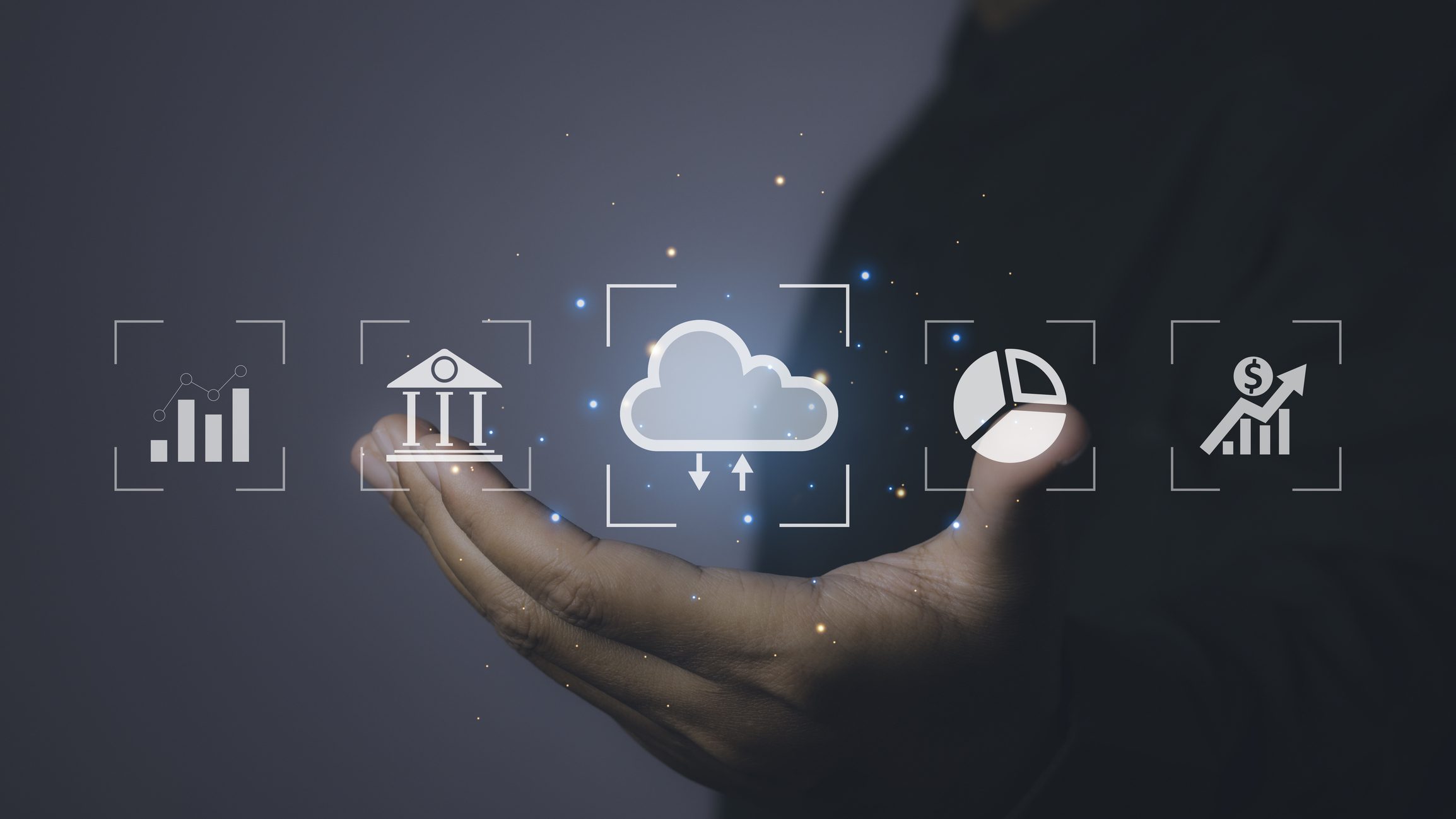 Business icons hovering above hand